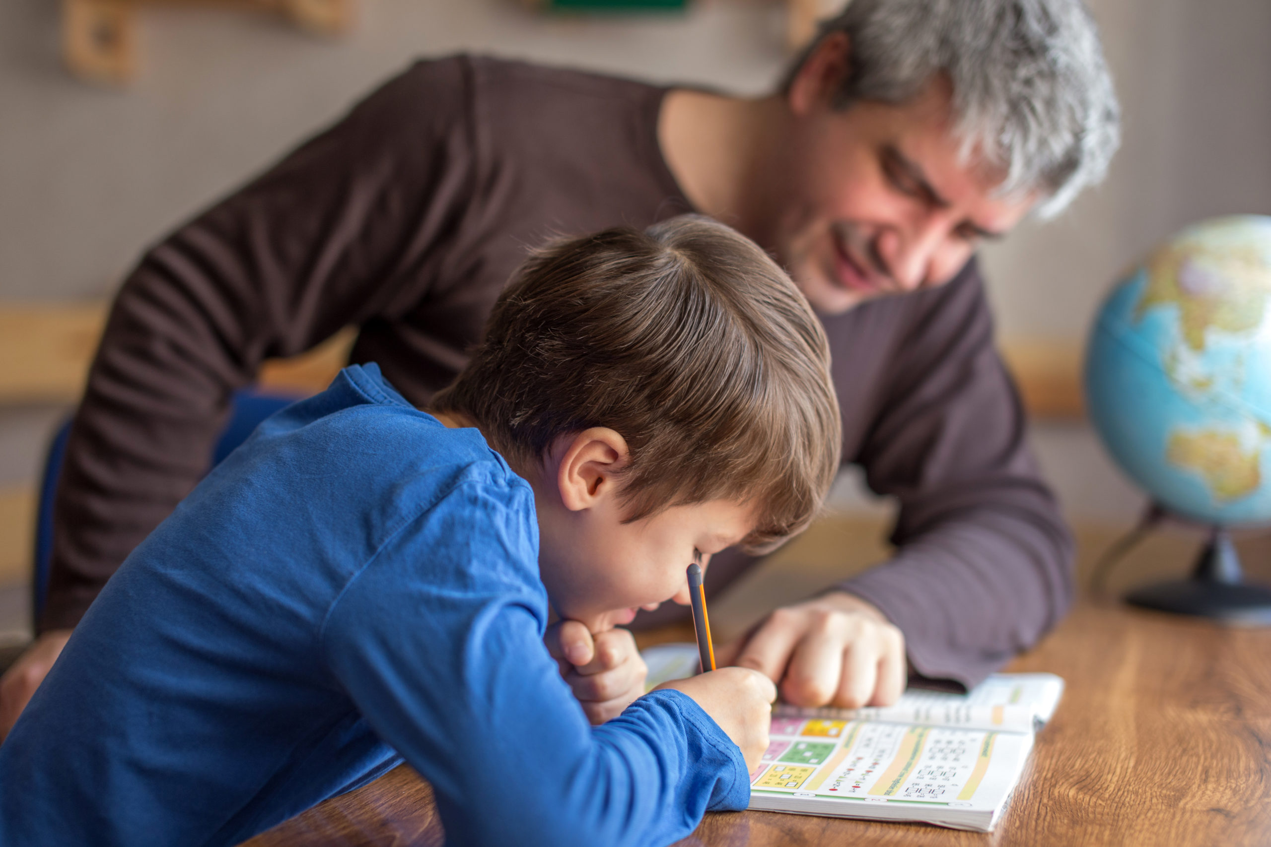 Image: A father and son doing exercises while teaching at home. Here’s what you need to know about Common Core for parents.
